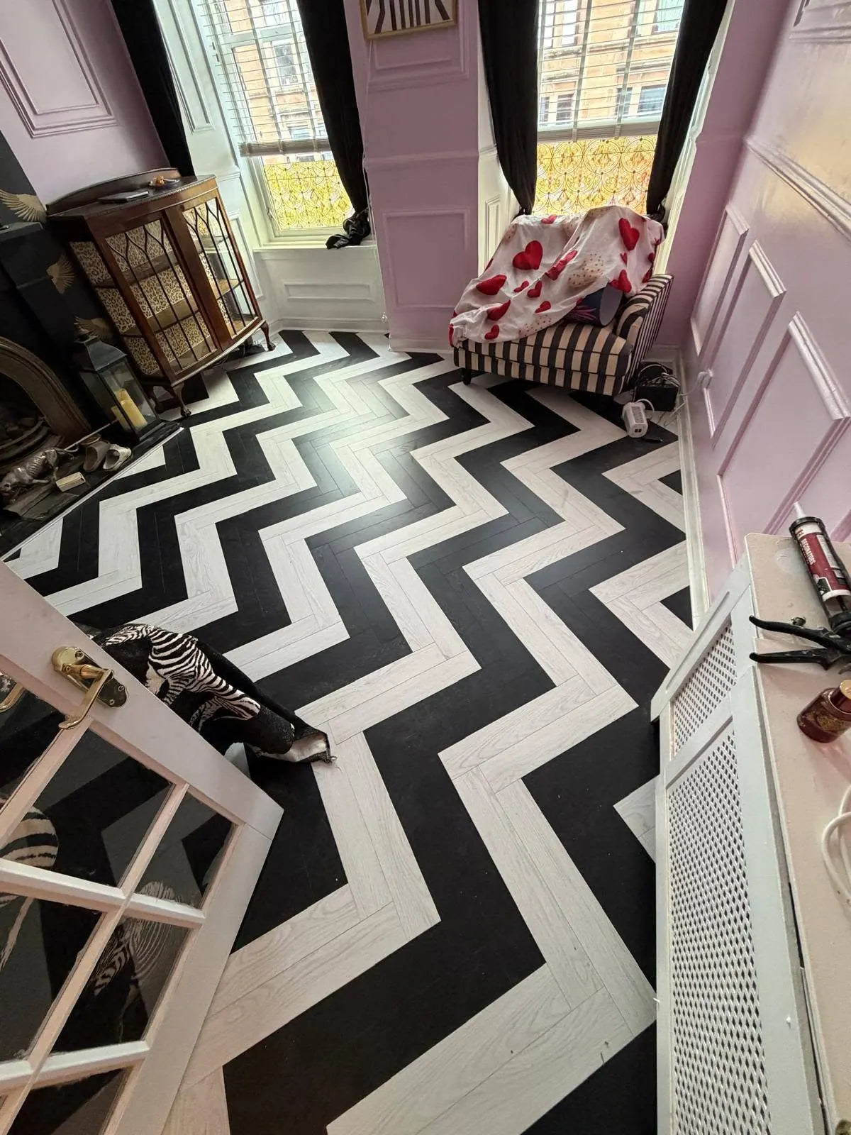 Contrasting black and white herringbone flooring fitted in a living room
